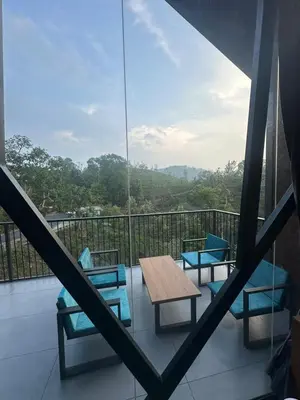 a balcony with chairs and a table and a view at Velora Hotel And Resorts in Devāla