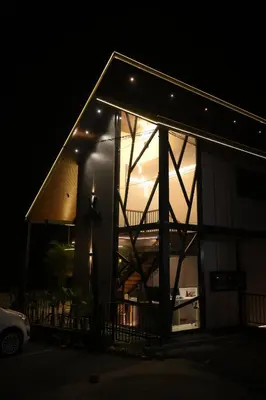 a lit up house at night with the lights on at Velora Hotel And Resorts in Devāla