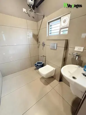 a bathroom with a toilet and a sink at Nvoyages Wayanad in Wayanad