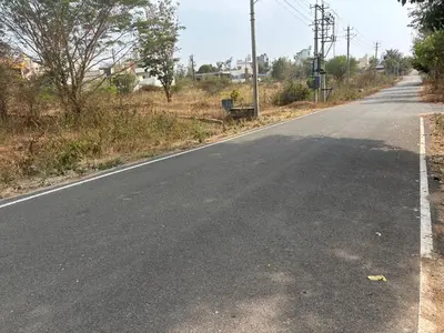an empty road in a rural area with trees at 4 Beds 6 People stay Calm, Comfortable Place in Mysore