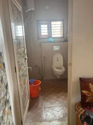 a small bathroom with a toilet and a window at 4 Beds 6 People stay Calm, Comfortable Place in Mysore