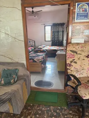 a room with two beds and a mirror at 4 Beds 6 People stay Calm, Comfortable Place in Mysore