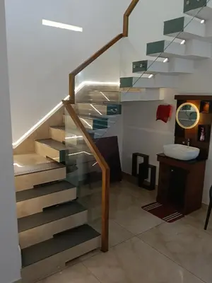 a bathroom with a staircase and a sink at Anjali Holiday Home in Tindummal
