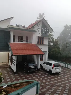 a car parked in front of a house at Anjali Holiday Home in Tindummal