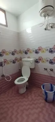 a bathroom with a toilet in a room at sarathihomestay in Vālpārai
