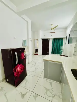 a kitchen with a refrigerator with a flower on it at MIRACLE INN Rajagiri in Cochin
