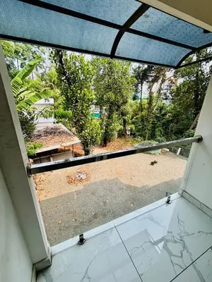 an open window with a view of a yard at MIRACLE INN Rajagiri in Cochin