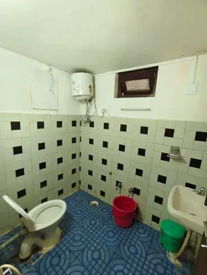 a bathroom with a toilet and a sink at MISTY cottage in Ooty