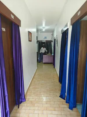 a corridor with blue and purple curtains in a hallway at MISTY cottage in Ooty
