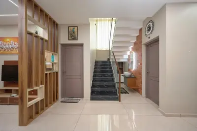 a hallway with a staircase in a house at 4-Bedroom Villa near CIAL Airport 25 Min Drive ! in Alwaye