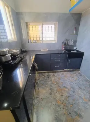 a kitchen with a counter and a counter top at Affordable home stay in Chāmrājnagar
