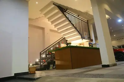 a staircase in a house with a stair case at Alpha Inn in Vālpārai