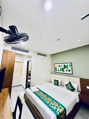 a bedroom with a large bed in a room at IGNIVA Airport Hotel in Calicut
