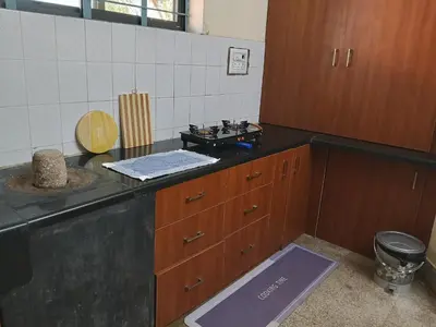 a kitchen with a sink and a counter top at Formula 1 Premium Villa in Mysore
