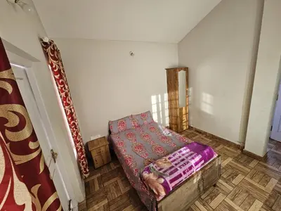a small room with a bed in a room at Grays club guest House in Coonoor