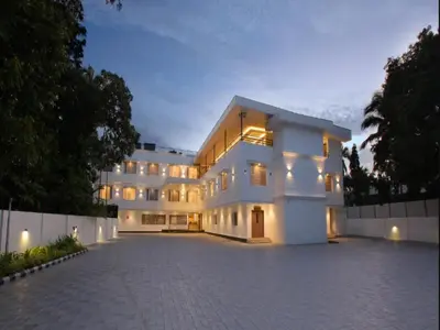 a large white building with a lot of windows at Hotel Salkara Chavakkad in Manattala
