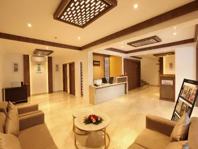 a large living room with a couch and a table at Hotel Salkara Chavakkad in Manattala