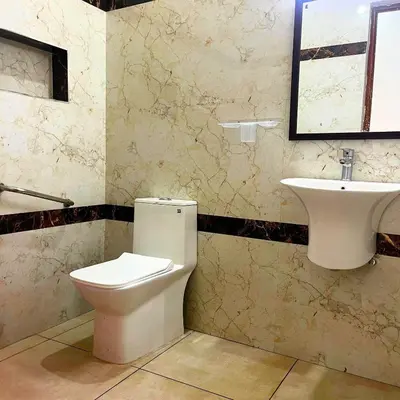 a bathroom with a toilet and a sink at Prysm Homestay - Kotagiri in Kotagiri