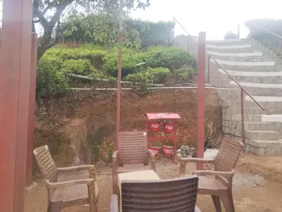 a group of chairs sitting next to some stairs at Janardan Campsite Ooty in Ooty