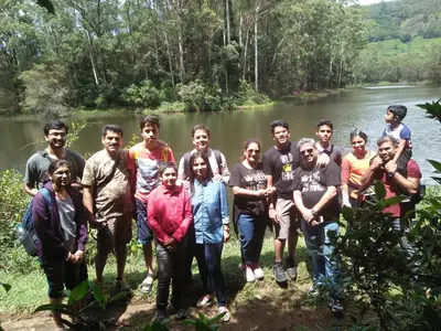 a group of people standing in front of a river at Oak and Sky Adventures, Kanthalloor in Kanthalloor