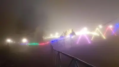 a bridge covered in christmas lights in the fog at Oak and Sky Adventures, Kanthalloor in Kanthalloor