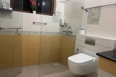a bathroom with a toilet and a shower at Heritage Home Near Cochin Airport in 5-Acre Farm in Angamali