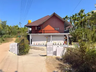 a house on the side of a dirt road at Evara Stays Coorg in Kushālnagar