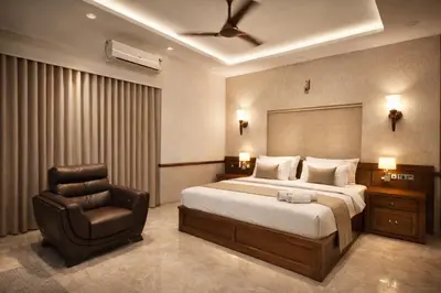 a bedroom with a bed and a chair at Amara Lux Rivage wynad in Vythiri