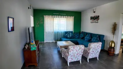 a living room with a blue couch and a table at Amariyah House -Luxury Villa in Coonoor in Coonoor