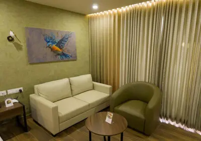 a living room with a couch and a chair at River Bay Athirappilly in Athirappilly
