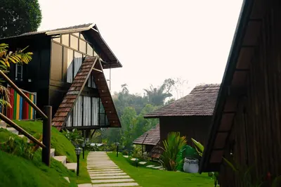 a house with a pathway between two buildings at Wood Panda Luxury Resort Wayanad in Meppādi