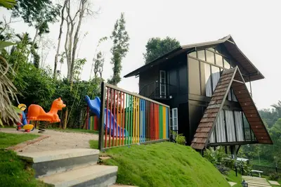 a small house with a colorful fence and a playground at Wood Panda Luxury Resort Wayanad in Meppādi