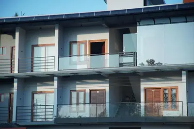 a facade of a building with balconies at Gentur Enclave in Mananthavady
