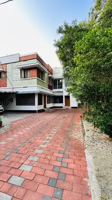 a red brick walkway in front of a building at Snehanilayam-1 in Trichūr