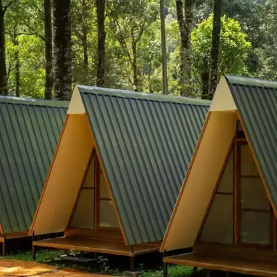 a row of modular homes with pitched roofs at Green mountain resort in Meppādi