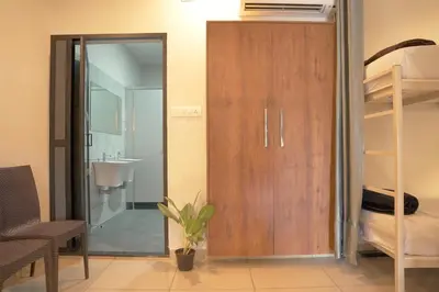 a room with a wooden closet and a bunk bed at Blue Vista Residency in Kalpetta