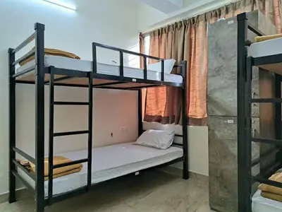 a room with two bunk beds in a room at cozstel in Kozhikode