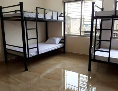 two bunk beds in a room with a window at cozstel in Kozhikode