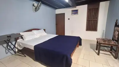 a bedroom with a bed and a desk and a chair at Heritage tharavadu in Mananthavady