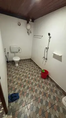 a bathroom with a toilet and a shower at Heritage tharavadu in Mananthavady