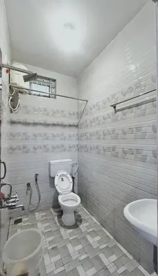 a bathroom with a toilet and a sink at The Misty Woods in Kotagiri