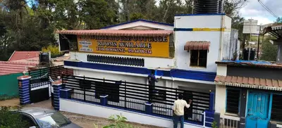 a man standing in front of a building at White House Cottage in Ooty