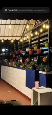 a produce section of a store with flowers and plants at White House Cottage in Ooty