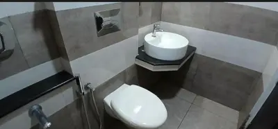 a bathroom with a sink and a toilet at krishna suites guruvayur in Guruvāyūr