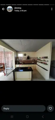 a view of a kitchen with a stove top oven at Glass house in Pollāchi