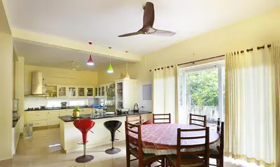 a kitchen with a table and chairs and a dining room at Family beach home-Cherai in Pallipuram