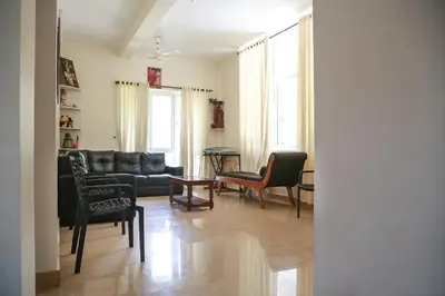 a living room with a couch and chairs and a table at Family beach home-Cherai in Pallipuram