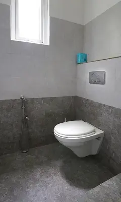 a bathroom with a toilet and a window at Family beach home-Cherai in Pallipuram
