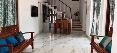 a hallway with two benches and a staircase at Bougainvilla Luxury Individual Villa Kozhikode in Kunnamangalam