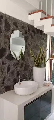 a bathroom with a sink and a mirror at Bougainvilla Luxury Individual Villa Kozhikode in Kunnamangalam
